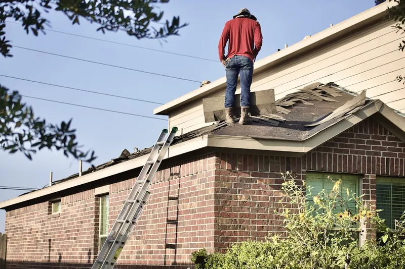 Professional roofer working on a residential roof in Wabasso
